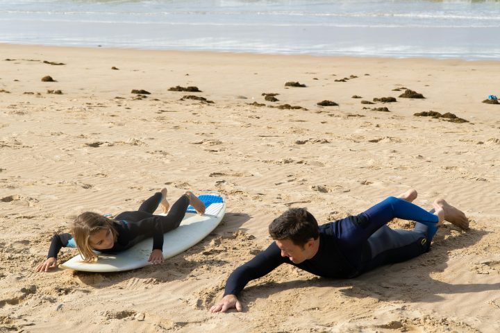 a person lying on a sandy beach
