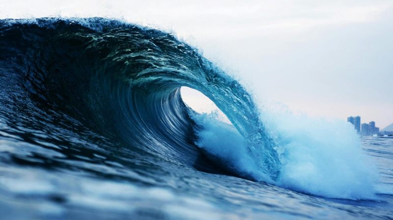 8014b958-a10a-46a9-a269-2afa2e0b4069 a man riding a wave on a surfboard in the water