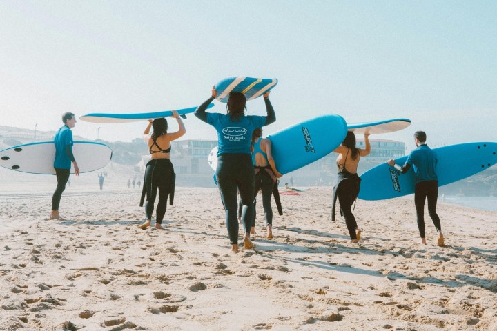 a group of people walking on a beach