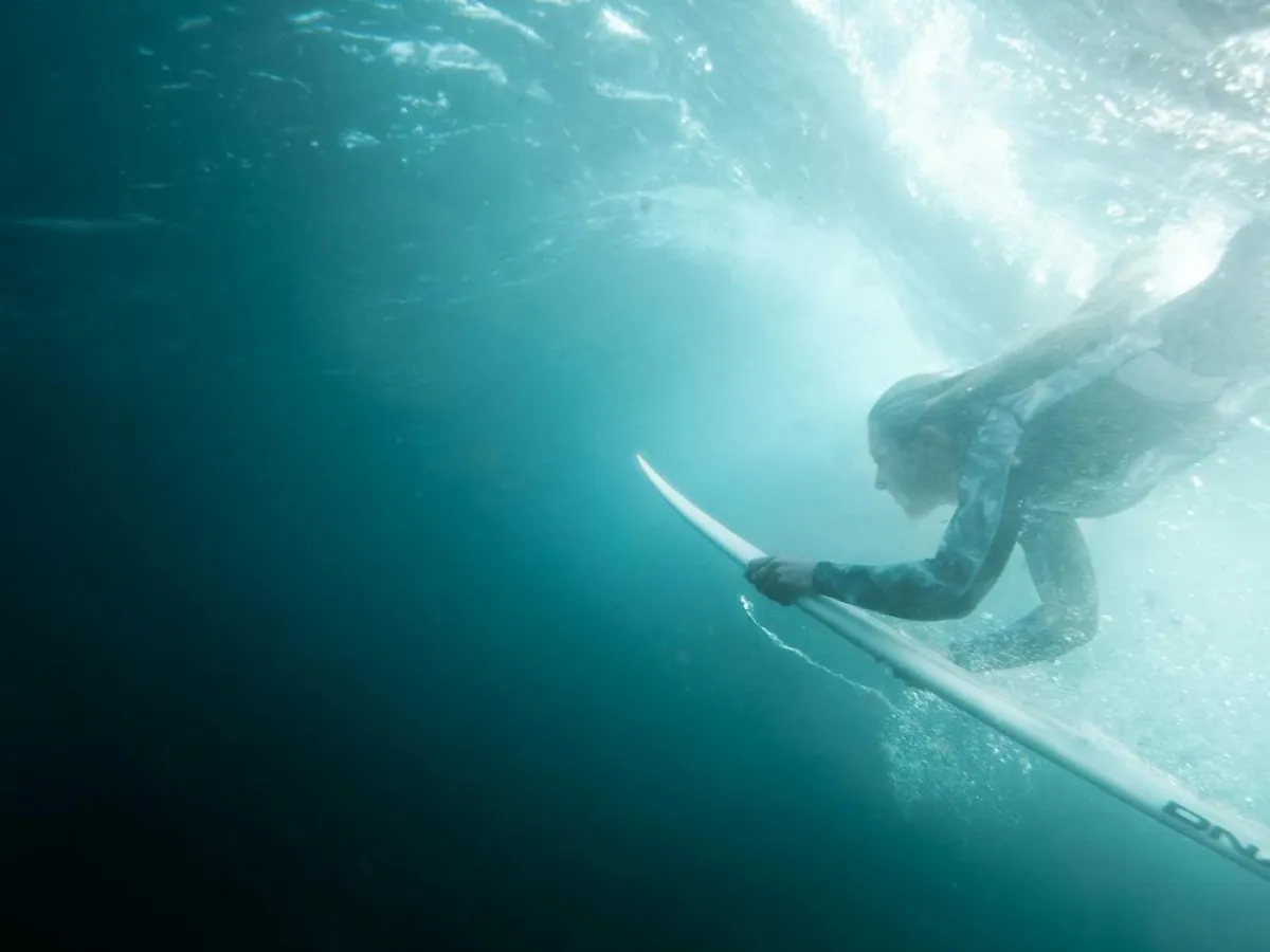 a man riding a wave on top of a body of water